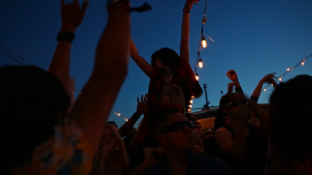 Guests dancing aboard the Dani Thorne boat rave at sunset